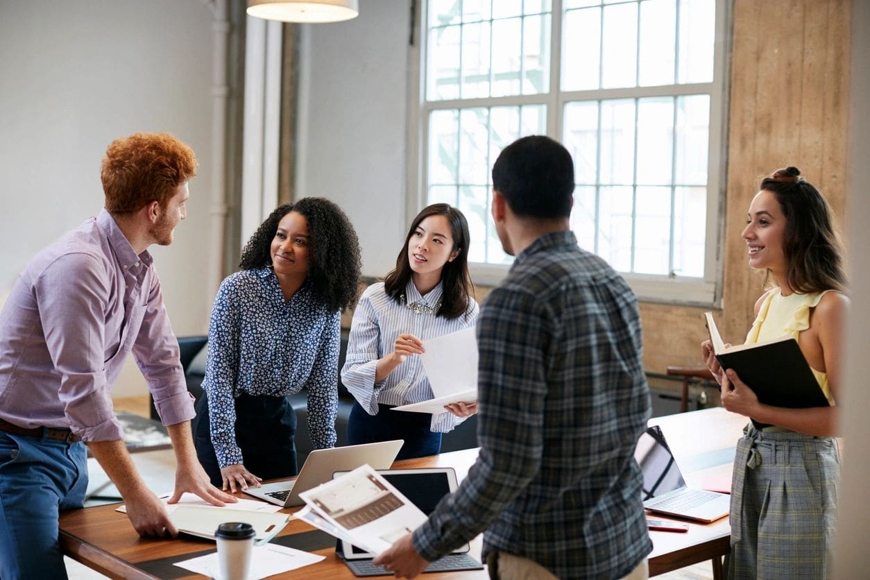 A group of people standing around a table.